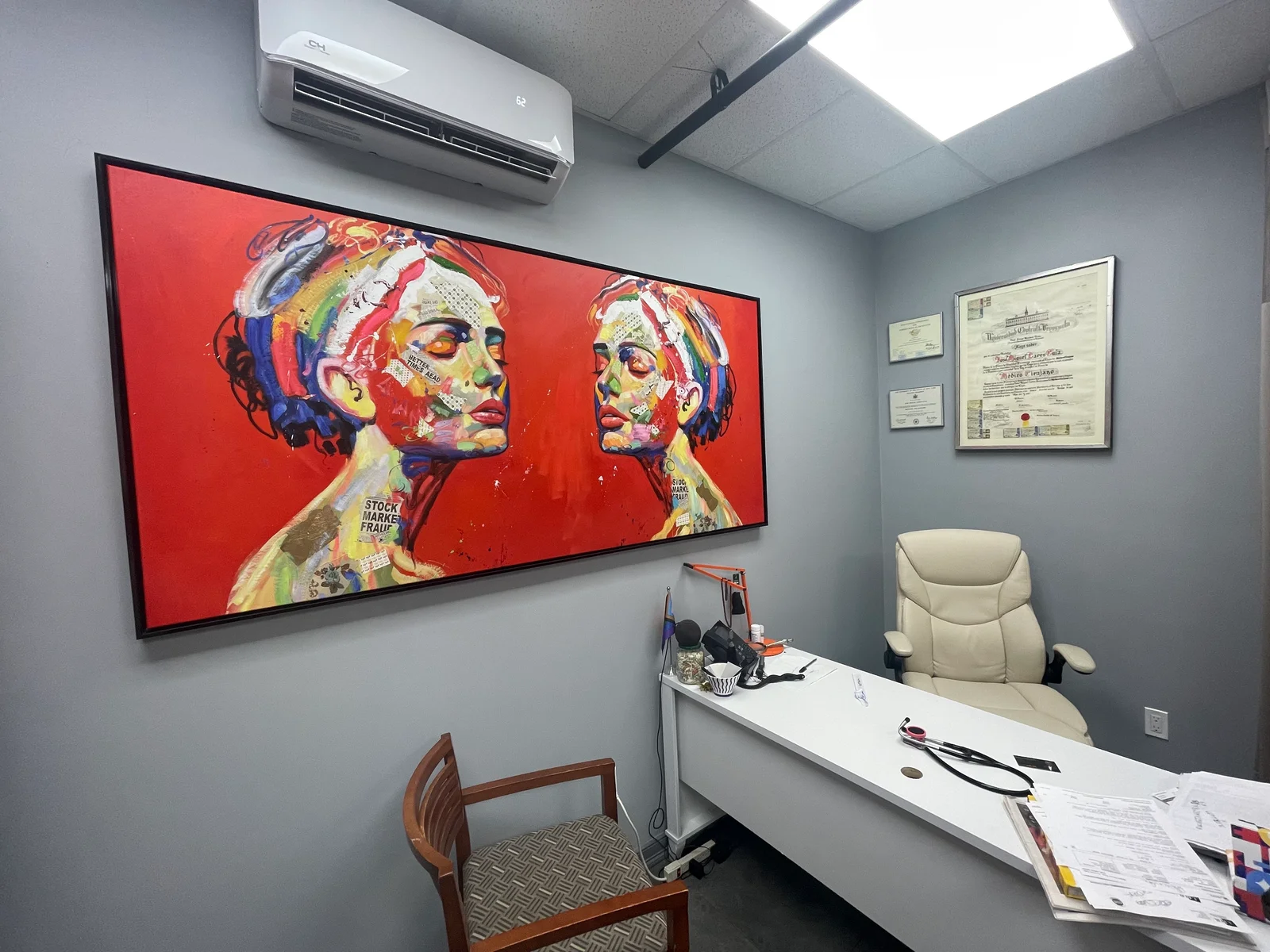 Ace Medical Care exam room with framed artwork and consultation desk
